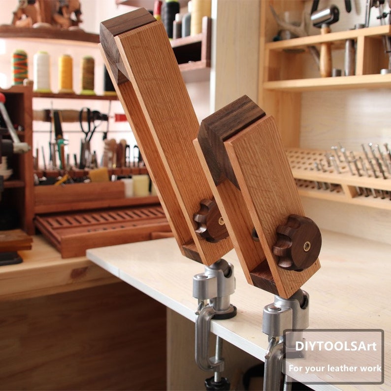 May include: Two wooden leathercraft clamps with adjustable knobs and metal bases. The clamps are made of light and dark brown wood. The text "DIYTOOLSArt" and "For your leather work" is visible in the bottom right corner.