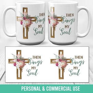 Könnte beinhalten: Eine weiße Keramiktasse mit einem braunen Holzkreuz und einem floralen Design. Der Text "Then Sings My Soul" ist auf die Tasse gedruckt.