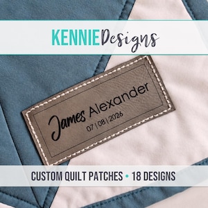 May include: A rectangular gray faux leather patch stitched onto a blue and white fabric quilt. The patch features the text James Alexander and the date 07 | 08 | 2026 in black ink. The text KENNIE Designs and CUSTOM QUILT PATCHES | 18 DESIGNS is visible.