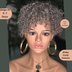 May include: A mannequin head with a short, gray, kinky curly wig. The mannequin wears large gold hoop earrings and a gold necklace with a pendant. The text "Kinky Curly Texture" is visible.