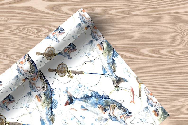 Wrapping paper featuring jumping bass fish, fishing rods, reels, and lures on a white background, unrolled with soft decor and a plush toy.