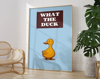May include: A blue and white poster with the text "WHAT THE DUCK" in brown letters. A cartoon yellow duck is in the bottom center of the poster.