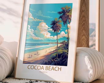 May include: A framed art print featuring a beach scene with palm trees, a sandy shore, and a bright blue sky. The print has the words "COCOA BEACH FLORIDA" in gold lettering at the bottom. The artwork is displayed in a light wood frame.