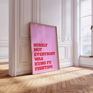 May include: A pink framed poster with the text "SURELY NOT EVERYBODY WAS KUNG FU FIGHTING" in red.