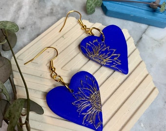 Heart shaped blue dangle earrings with sunflower embossed polymer clay sunflower earrings