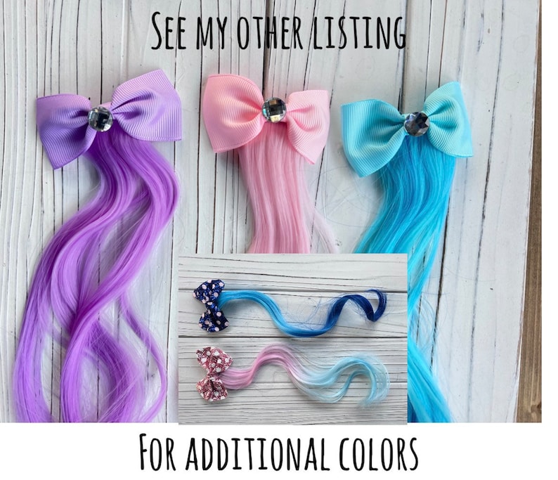 May include: Three hair clips with bows and attached hair extensions. The bows are purple, pink, and blue. The hair extensions are purple, pink, and blue. The text "See my other listing for additional colors" is at the bottom of the image.