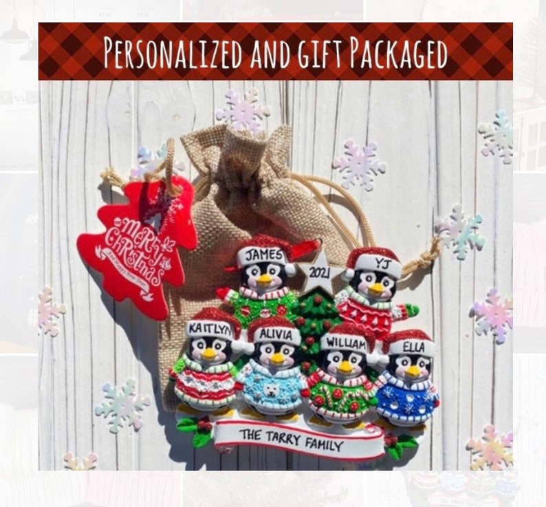 May include: A personalized Christmas ornament featuring a family of penguins, each with a name on their hat. The ornament includes a Christmas tree and is packaged in a burlap bag with a red tree-shaped tag that says "Merry Christmas". The text "The Tarry Family" is on a banner.