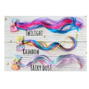 May include: Three colorful hair extensions with unicorn clips. The extensions are labeled "Twilight", "Rainbow", and "Fairy Dust".