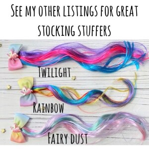 May include: Colorful hair extensions in Twilight, Rainbow, and Fairy Dust colors. Each extension is attached to a bow with a unicorn charm. The text at the top says "See my other listings for great stocking stuffers."