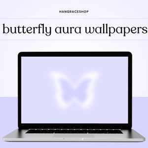 May include: A laptop computer screen displaying a purple butterfly aura wallpaper. The butterfly is a light purple color and is in the center of the screen.