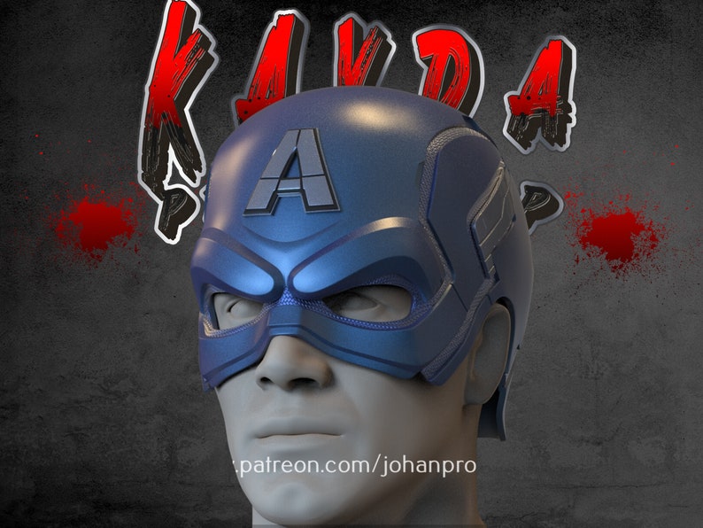Op de afbeelding: Een blauwe en zilveren Captain America helm met een rode, witte en blauwe A aan de voorkant. De helm zit op een mannequinhoofd. De achtergrond is een grijze muur met rode verfspatten.