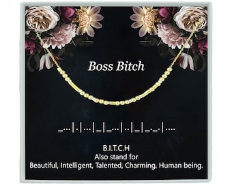 May include: A gold necklace with the words "Boss Bitch" and the acronym "B.I.T.C.H." which stands for "Beautiful, Intelligent, Talented, Charming, Human being."