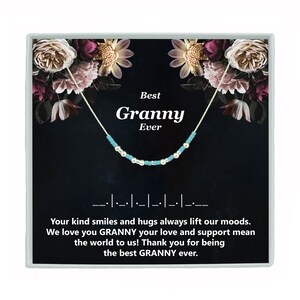 May include: A silver necklace with turquoise beads and a card that reads "Best Granny Ever". The card has a floral background and the text "Your kind smiles and hugs always lift our moods. We love you GRANNY your love and support mean the world to us! Thank you for being the best GRANNY ever."