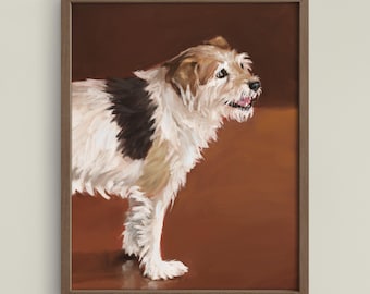May include: A framed painting of a terrier-mix dog. The dog has white, brown, and black fur. The painting is set against a brown background. The dog is standing and looking to the right. The frame is a dark brown colour.