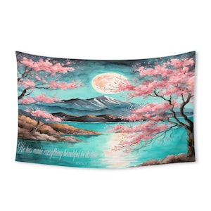 May include: A wall tapestry featuring a watercolor landscape with a full moon, mountains, and a lake. Pink cherry blossom trees frame the scene. The text "He has made everything beautiful in its time" is included.