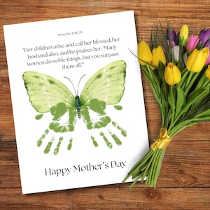 May include: A white card with a green butterfly made from handprints. The card has the text "Proverbs 8:28 29" and a quote about mothers. The card also says "Happy Mother's Day". A bouquet of yellow, purple, and white tulips is in the background.