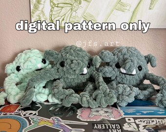 May include: Three crocheted plush creatures in light mint, sage green, and dark grey. Each has black safety eyes, a small white tooth, and long, textured limbs. The text "digital pattern only" and "@jfs.art" is visible above the plushies.