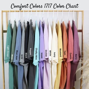 May include: A color chart of 14 different t-shirt colors from Comfort Colors 1717. The colors are: Light Green Moss, Blue Jean, Gray, Black, Pepper, Chalky Mint, Violet, Orchid, White, Ivory, Mustard, Yam, Cumin, and Berry.