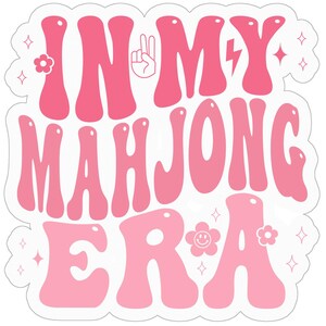 May include: Pink and white sticker with the text "In My Mahjong Era" in a retro font. The sticker features peace signs, lightning bolts, and flowers.