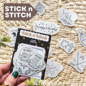 May include: A collection of "Stick n' Stitch" embroidery patches with various designs, including hockey jerseys, maple leaves, and the text "I'm coming to the cottage." The patches are displayed on a woven background, with the brand name "Stick n' Stitch" prominently featured.