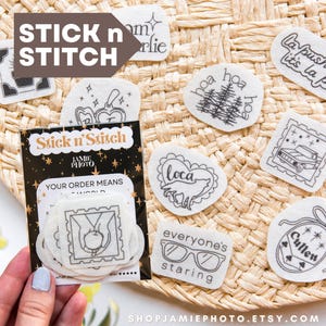 May include: A collection of white adhesive embroidery stabilizer patches featuring black line art designs including text like La Push baby, Cullen, and everyone's staring, with a branded Stick n Stitch packaging sleeve.