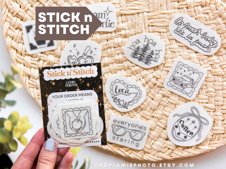 May include: A collection of white adhesive embroidery stabilizer patches featuring black line art designs including text like La Push baby, Cullen, and everyone's staring, with a branded Stick n Stitch packaging sleeve.
