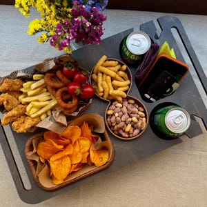 Gray Couchbar wooden serving tray full of snacks