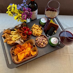 Cozy home decor featuring a custom snack board on couch armrest