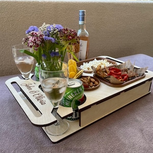 Gift for him – sofa organizer holding wine, snacks, and phone on couch arm