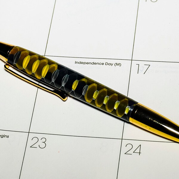 Handmade Gold Delvin click pen with a yellow and gold honeycomb body