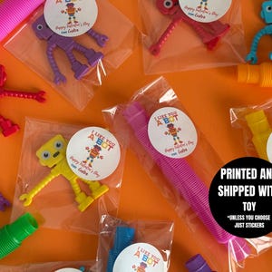 May include: Assortment of small robot toys packaged in clear plastic bags with colorful stickers that say "I Like You A Bot" and "Happy Valentine's Day Gabe".