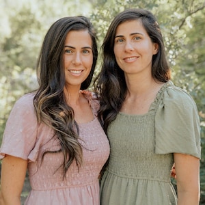 May include: Two women wearing pink and green dresses stand in front of a green leafy background. The women are smiling and looking at the camera. The text "THANK YOU FOR SUPPORTING HANDMADE AND SMALL BUSINESSES LIKE OURS. YOUR SUPPORT MEANS THE WORLD FOR US." is displayed above the women.