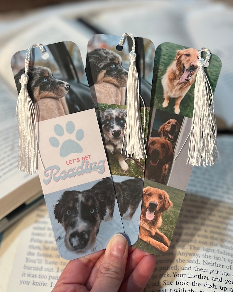 May include: Three bookmarks with different dog photos. Each bookmark has a white tassel and a paw print with the text "Let's Get Reading".