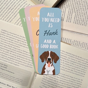 May include: Four colorful bookmarks with different quotes. The blue bookmark features a brown and white dog with the text "All you need is Hank and a good book".