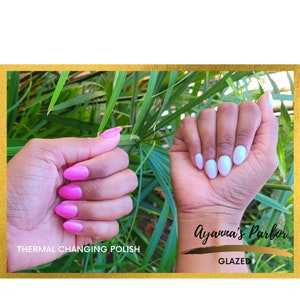 May include: Two hands with manicured nails. One hand has pink thermal changing polish and the other hand has white glazed polish. The text "Thermal Changing Polish" is below the pink nails and the text "Ayanna's Parlor Glazed" is below the white nails.
