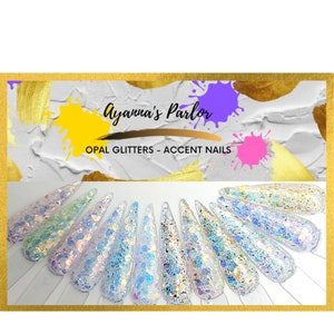 May include: Ayanna's Parlor Opal Glitters - Accent Nails. A close-up of 12 iridescent nail tips with different shades of opal glitter.