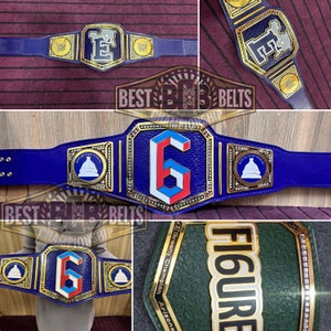 May include: A blue and gold championship belt with a large gold number "6" in the center. The belt has a blue strap with gold accents and a gold buckle with a white building design. The belt is decorated with rhinestones and has the text "BEST BELTS CHAMPIONSHIP" on the buckle.