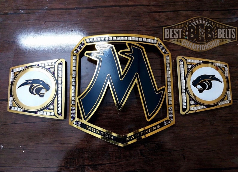 May include: Gold championship belt with black and white panther logo, the words "Morton Panthers" and the text "BEST BB BELTS CHAMPIONSHIP".