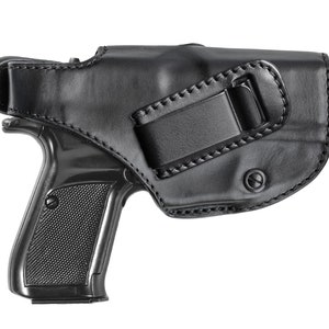 May include: Black leather holster with a belt clip for a handgun.