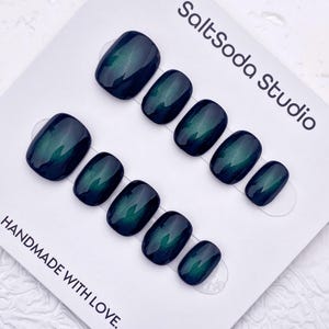 May include: Set of press-on nails in a dark teal color with a glossy finish. The nails are arranged on a white card with the text "SaltSoda Studio" and "HANDMADE WITH LOVE."
