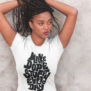 May include: White t-shirt with a black graphic that says "Make Dope Stuff Every Day".