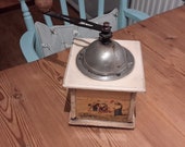 A vintage very unusual rare coffee grinder retro, farmhouse kitchen, rustic.Depicting the painting quot The Gleaners quot