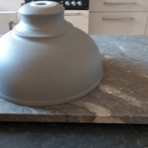 A retro industrial type lampshade in matt grey metal white interior.