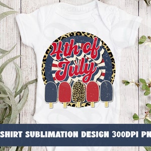 May include: A white t-shirt with a red, white, and blue 4th of July design featuring a circle with a starburst pattern and the text "4th of July".  Five popsicle-shaped graphics are arranged below the circle, with red, white, and blue colors.
