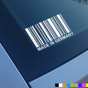 May include: A white sticker with a barcode and the text "Made in Germany" on a blue car window.