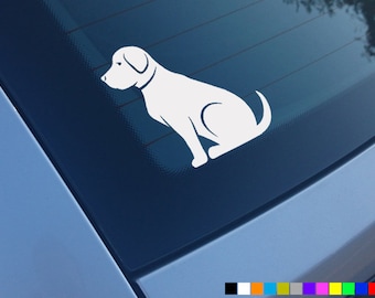 May include: White vinyl decal of a dog sitting with its head turned to the left. The decal is on a blue car window.