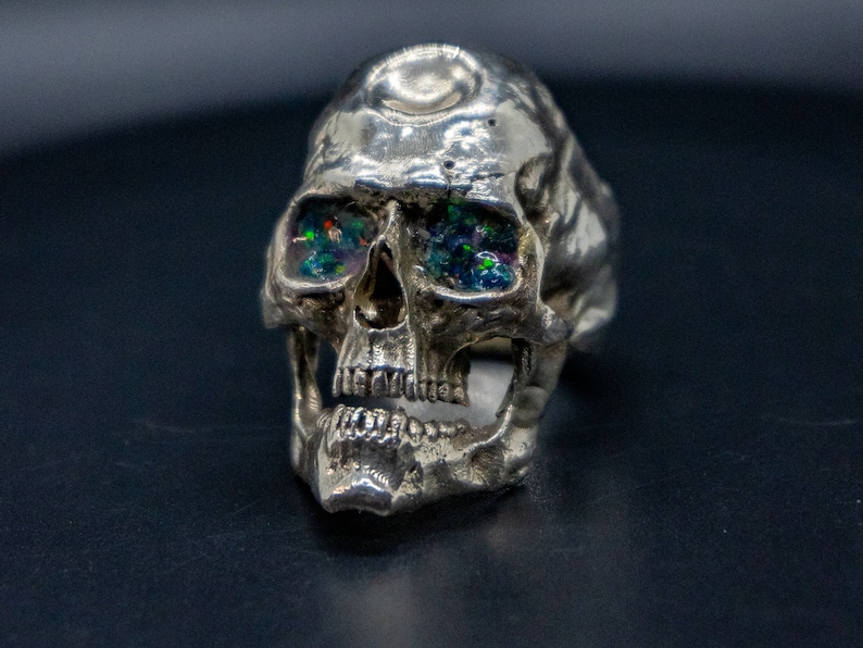 golden skull ring based on argus panoptes the greek one hundred eyed cyclops crushed opal set eyes front view