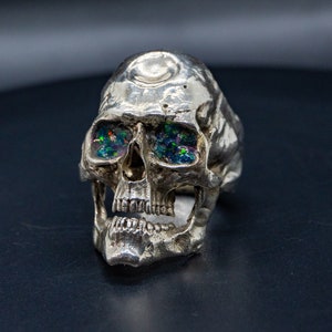 silver skull ring based on argus panoptes the greek one hundred eyed cyclops crushed opal set eyes