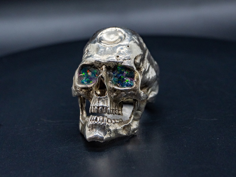 silver skull ring based on argus panoptes the greek one hundred eyed cyclops crushed opal set eyes