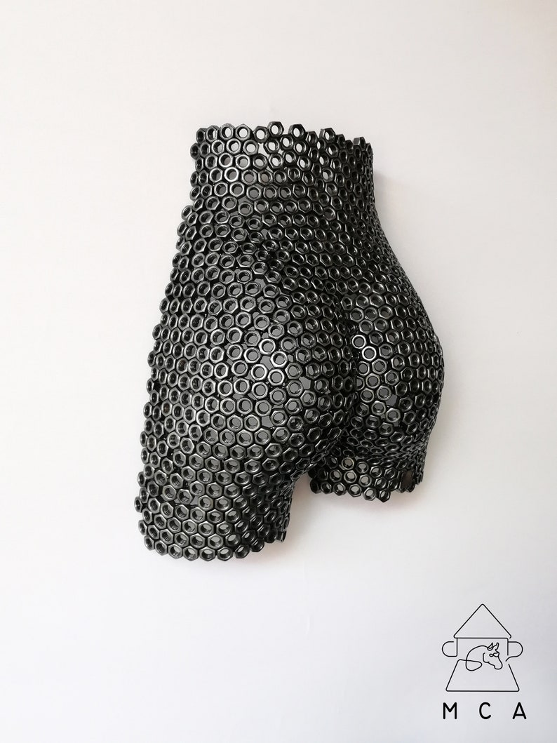 May include: A black metal sculpture of a human form made entirely of nuts and bolts.